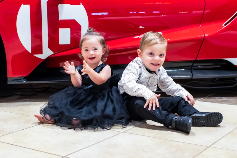 kids in front of red Ford